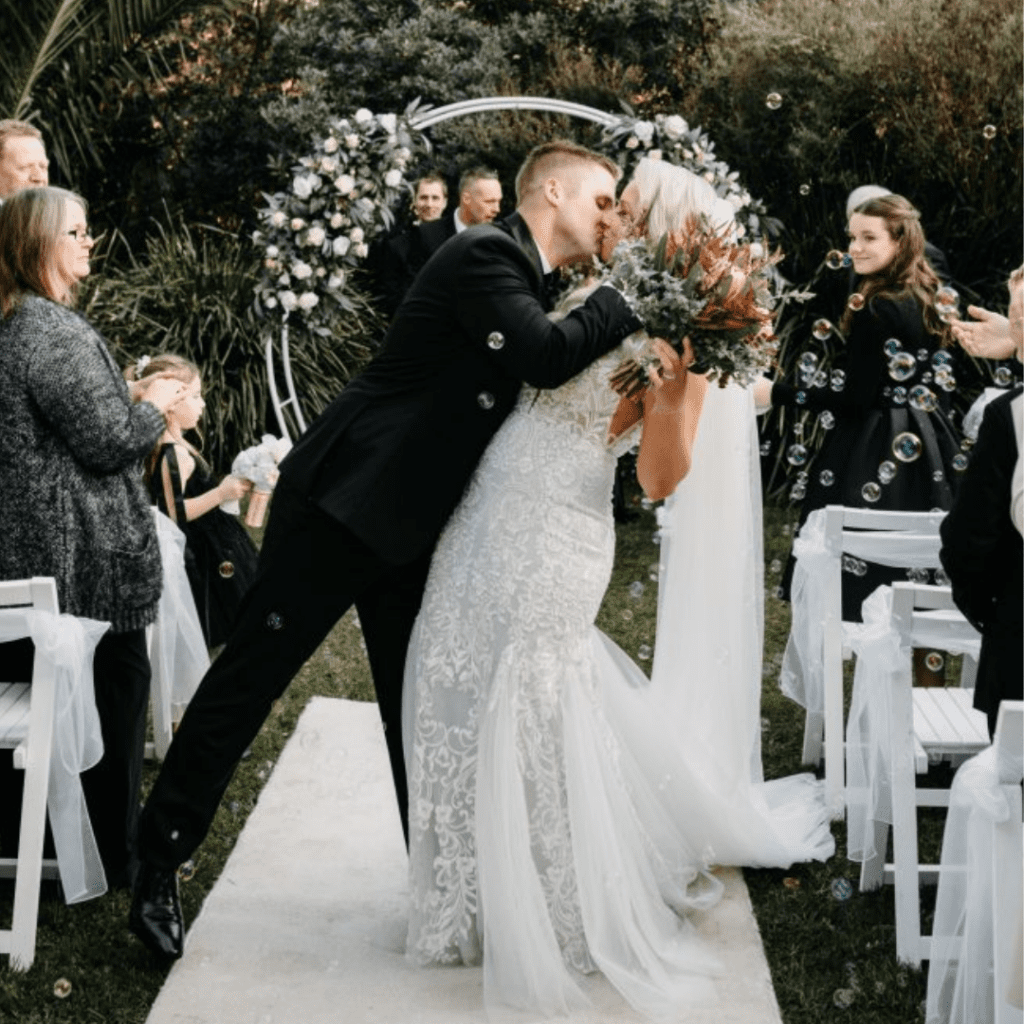 Bride and groom sharing their first kiss after their Melbourne Zoo wedding ceremony